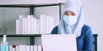 Muslim businesswoman wear protective masks during work in office